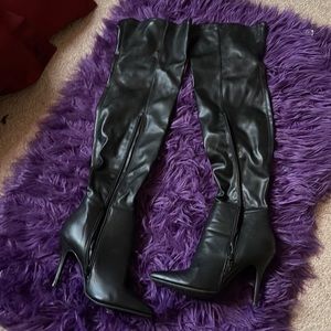 Thigh high black boots.